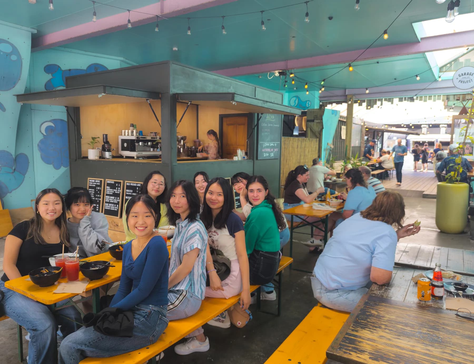 Customers gathered beside the JuSea juice bar at Liardet Street Projects