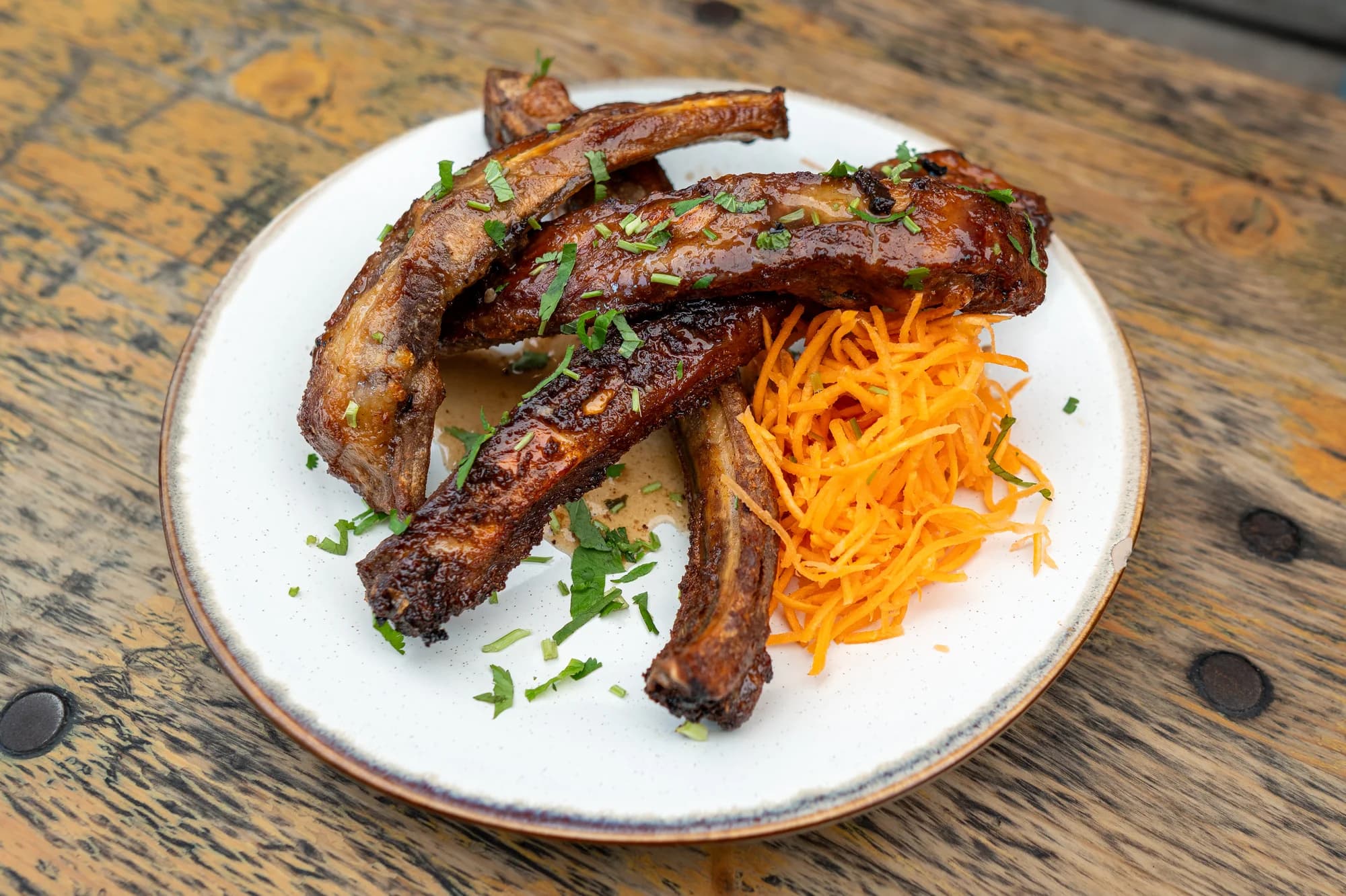 Glazed ribs with shredded carrot and herbs at Viet Nom Nom, New Plymouth