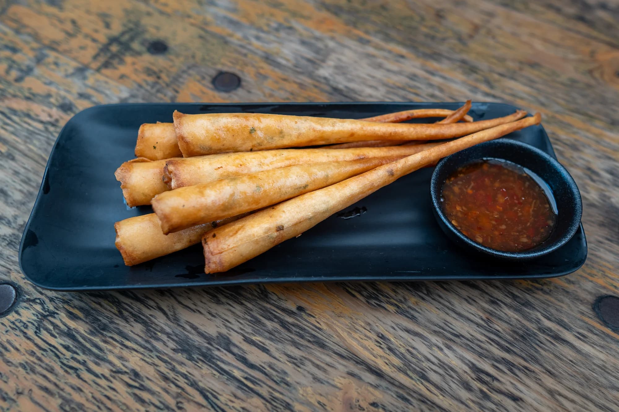 Long golden rolls with dipping sauce at Viet Nom Nom, New Plymouth
